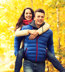 Image showing smiling couple having fun in autumn park