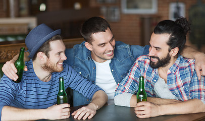 Image showing happy male friends drinking beer at bar or pub