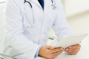 Image showing close up of male doctor hands with tablet pc