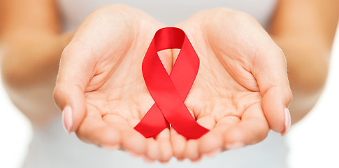 Image showing hands holding red AIDS awareness ribbon