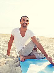 Image showing man doing yoga exercises outdoors