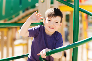 Image showing happy little boy climbing on children playground