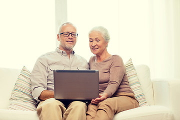 Image showing happy senior couple with laptop at home