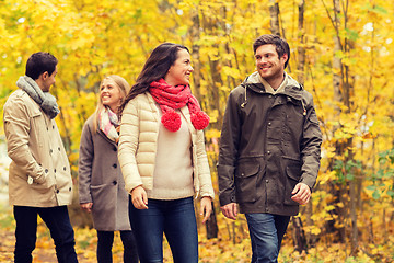 Image showing group of smiling men and women in autumn park