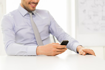 Image showing close up of businessman with smartphone texting