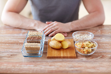 Image showing close up of male hands with carbohydrate food