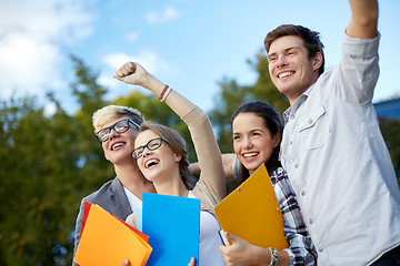 Image showing group of happy students showing triumph gesture