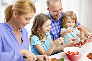 Image showing happy family with two kids cooking at home