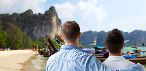 Image showing close up of male gay couple hugging on beach