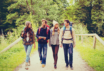 Image showing group of friends with backpacks and tablet pc