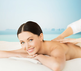 Image showing happy beautiful woman having back massage