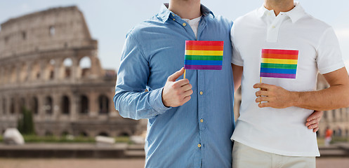 Image showing close up of male gay couple with rainbow flags