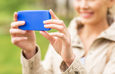 Image showing close up of woman taking picture with smartphone