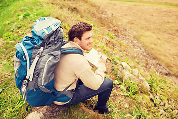 Image showing smiling man with backpack hiking