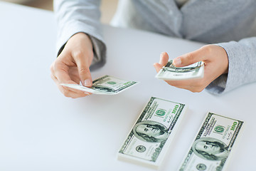 Image showing close up of woman hands counting us dollar money