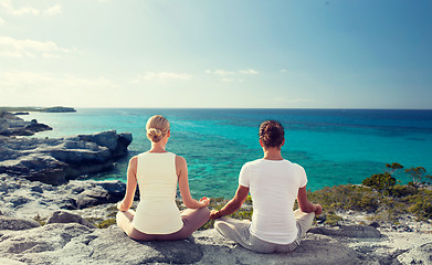 Image showing couple making yoga exercises outdoors