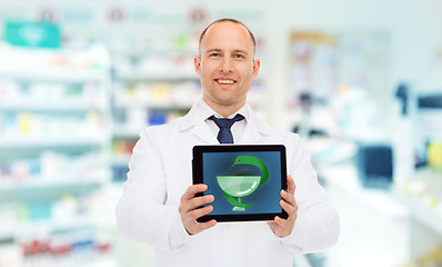 Image showing smiling male doctor with tablet pc at drugstore