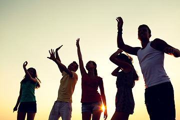 Image showing smiling friends dancing on summer beach