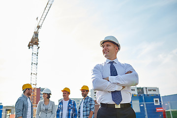 Image showing happy builders and architect at construction site