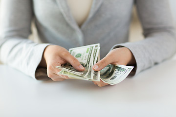 Image showing close up of woman hands counting us dollar money