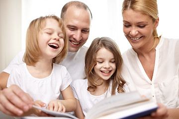 Image showing happy family reading book at home