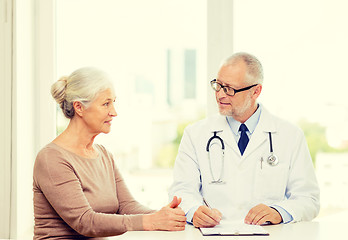 Image showing smiling senior woman and doctor meeting