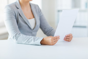 Image showing close up of woman reading papers or tax report