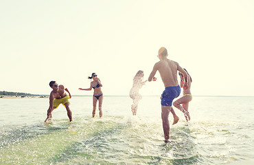 Image showing happy friends having fun on summer beach