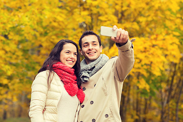 Image showing smiling couple hugging in autumn park