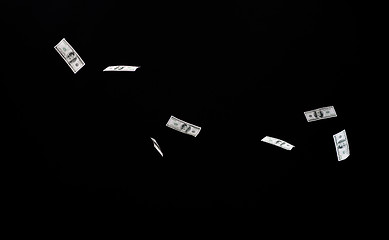 Image showing close up of us dollar money flying over black