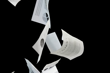 Image showing business papers falling down over black background