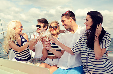 Image showing smiling friends with glasses of champagne on yacht