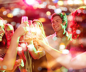 Image showing smiling friends with glasses of champagne in club