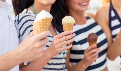 Image showing close up of happy friends eating ice cream