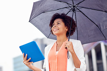 Image showing businesswoman with umbrella and tablet pc in city