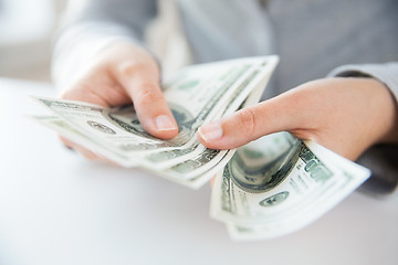 Image showing close up of woman hands counting us dollar money