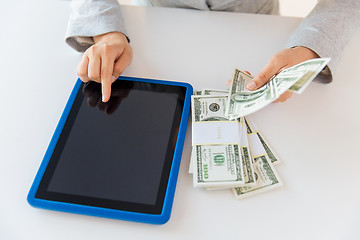 Image showing close up of woman hands with tablet pc and money