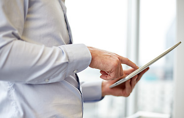 Image showing businessman with tablet pc in office