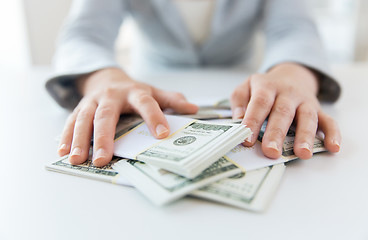 Image showing close up of woman hands counting us dollar money