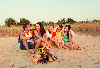 Image showing smiling friends in sunglasses on summer beach