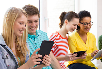 Image showing smiling students with tablet pc at school