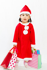 Image showing Asian Little Santa Claus with shopping bag
