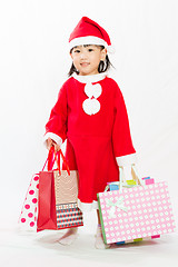 Image showing Asian Little Santa Claus with shopping bag