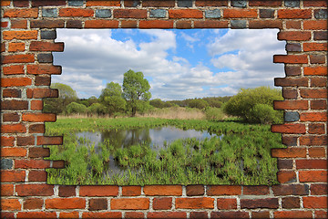 Image showing broken brick wall and view to spring landscape