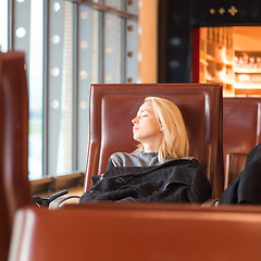 Image showing Tired female traveler waiting for departure.