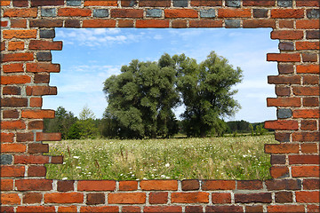 Image showing broken brick wall and view to summer landscape