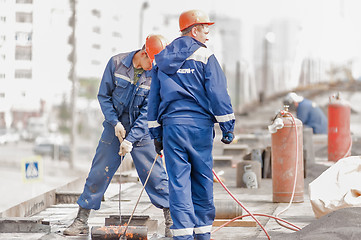 Image showing Workers make waterproofing of seams on the bridge