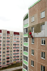 Image showing specialist carring out warming of building's wall