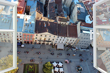 Image showing opened window to the roofs of city