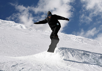 Image showing Snowboarder jumping